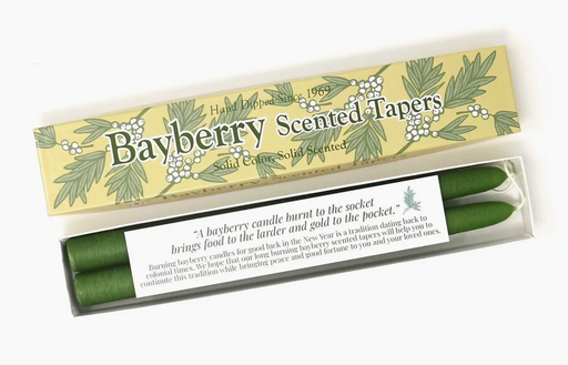 A pair of green bayberry scented taper candles in a packaging box with 'Bayberry Scented Tapers' text and leaf patterns.