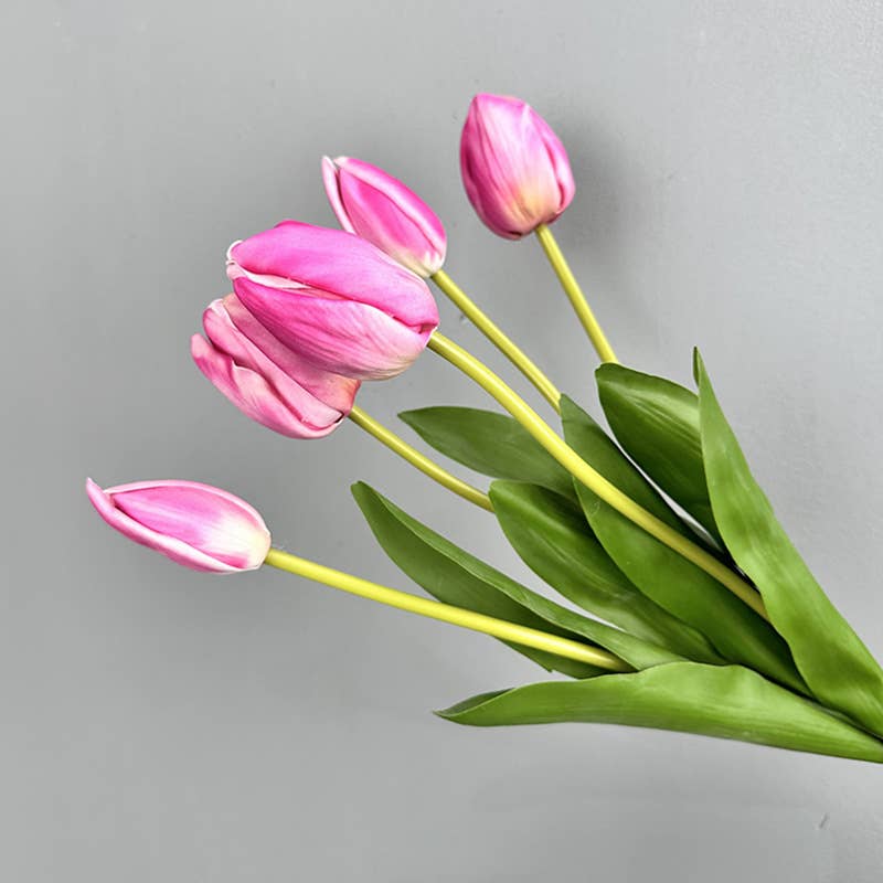 Bouquet of hot pink tulips with green leaves on a gray background - realistic faux tulips - look like from a New England Country Garden