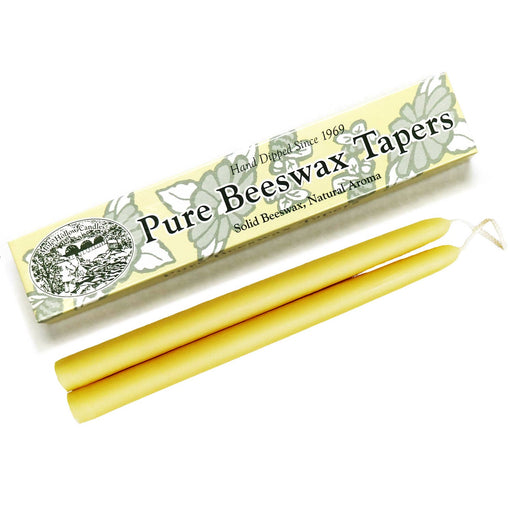 A pair of pure beeswax taper candles next to their packaging, labeled 'Mole Hollow Candles', depicting floral designs.