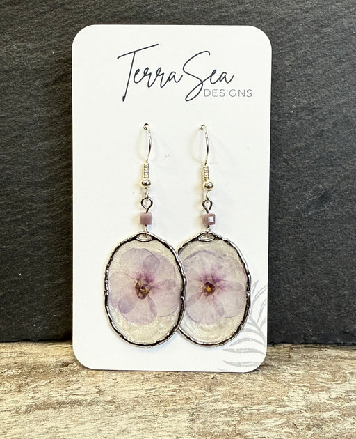 Pair of earrings on a card with 'Terra Sea Designs' branding against a dark background.