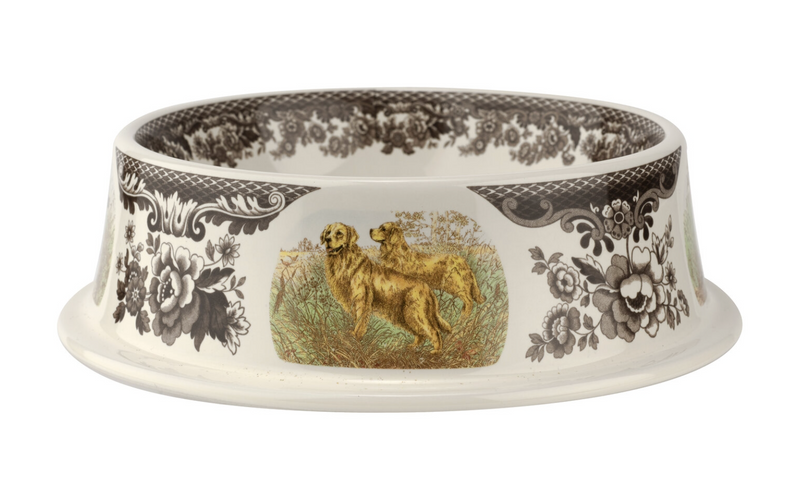 A ceramic pet bowl with a floral and animal pattern, featuring a Woodland theme with dogs and flowers on the exterior.