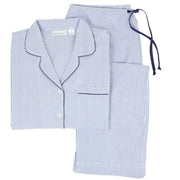 A set of long sleeve pajamas with blue and white stripes and navy piping, including a button-front top with a notched collar and side slits, and matching full-length pants with side-seam pockets and an elastic waistband with a drawstring.