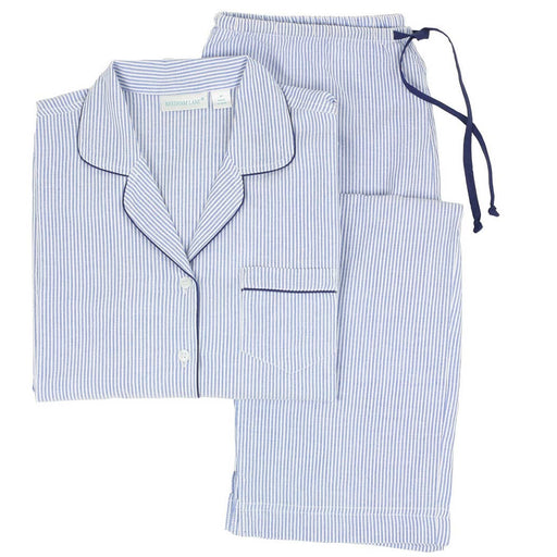 A set of long sleeve pajamas with blue and white stripes and navy piping, including a button-front top with a notched collar and side slits, and matching full-length pants with side-seam pockets and an elastic waistband with a drawstring.