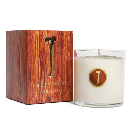 A white candle in a clear glass container, with a wooden box packaging that reads 'Cedar Wood Candle'.