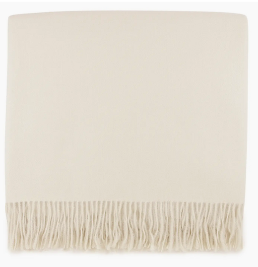Beige throw blanket with fringes on a white background