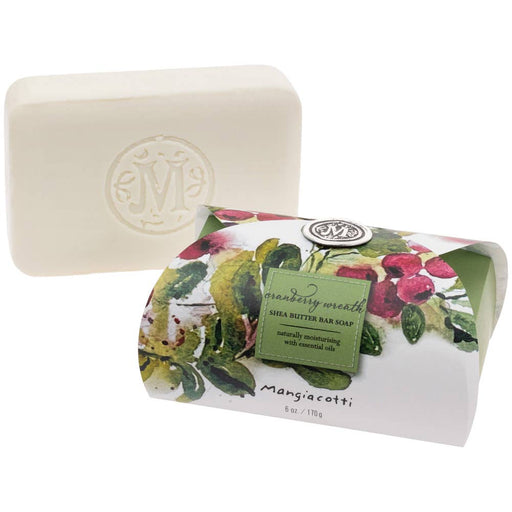 Bar of soap with floral packaging and a visible brand logo on a white background